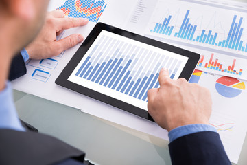 Businessman Analyzing Graph On Digital Tablet