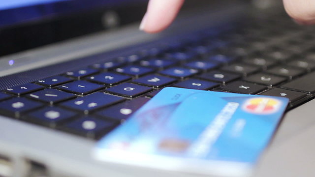 Christmas gifts - Woman holding credit card on laptop for online shopping