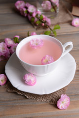 Beautiful fruit blossom with cup of tea