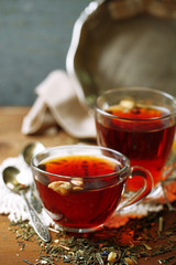 Beautiful vintage composition with herbal tea, on wooden table