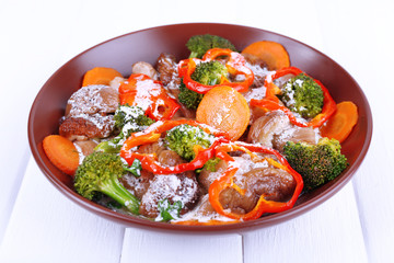 Braised wild mushrooms with vegetables and sauce in plate
