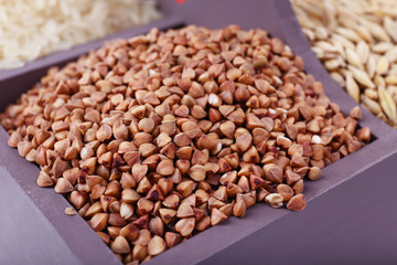 Groats in wooden box closeup