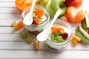 Healthy dessert with muesli and fruits on table