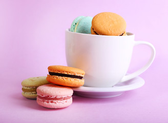 Assortment of gentle colorful macaroons in colorful mug