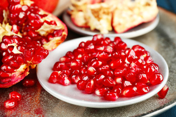 Juicy ripe pomegranates on wooden table