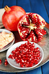 Juicy ripe pomegranates on wooden table