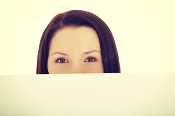 Woman's face behind copy space.