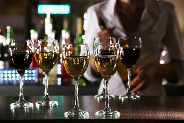 Bartender working at counter on bar background
