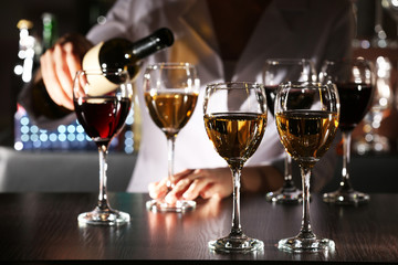 Bartender working at counter on bar background