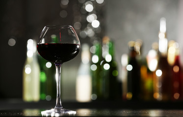 Glass of red wine in bar on blurred background