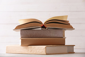 Stack of books on color wooden planks background