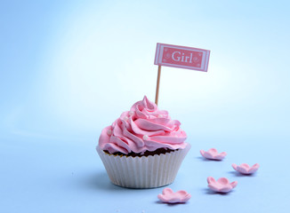 Delicious cupcake with inscription on table on blue background