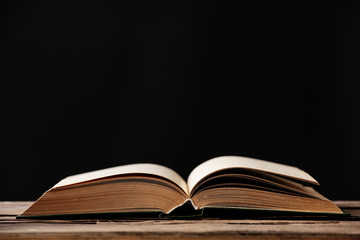 Open book with light over dark background