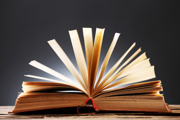 Open book over dark colorful background