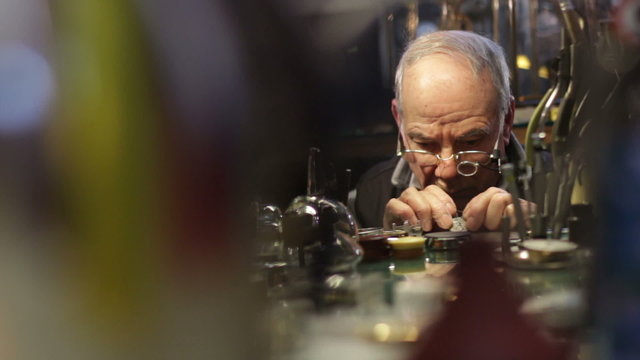 Watchmaker checks the operation of a repair