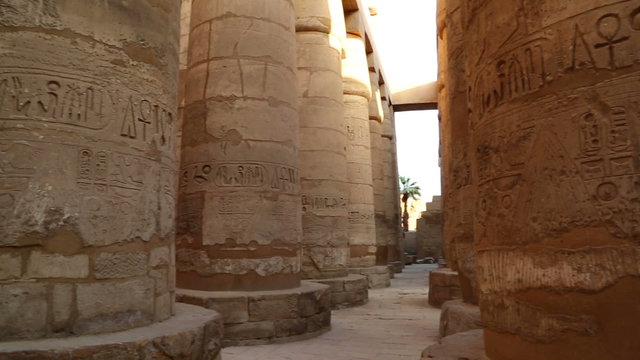 columns in karnak temple with ancient egypt hieroglyphics - pan 
