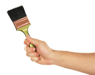 Paintbrush in male hand isolated on white