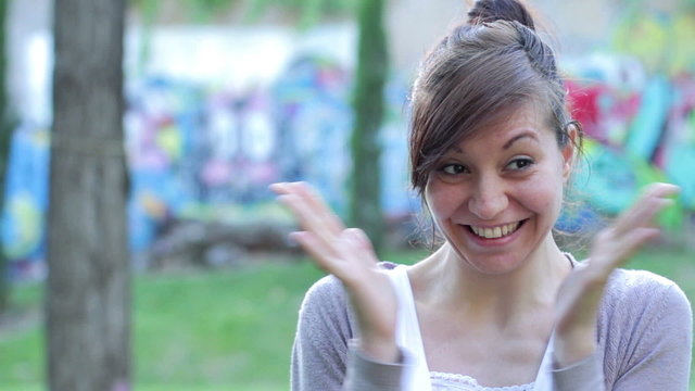 timid woman laughing and looking at the camera