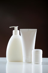 Group of cosmetic bottles on dark background