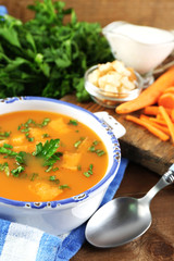 Composition with carrot soup, ingredients and herbs