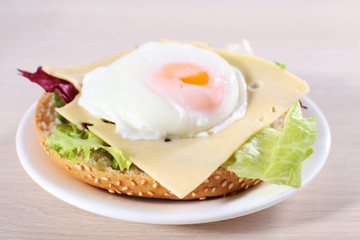 Sandwich with poached egg, cheese and greens