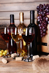 Different wine on table on wooden background