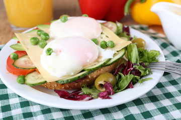 Sandwich with poached eggs, cheese and vegetables