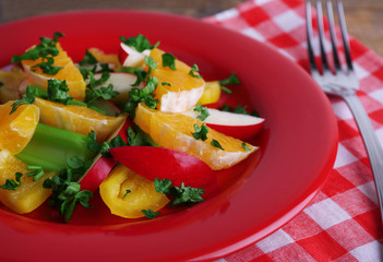 Waldorf salad with orange on plate on table close up