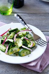Salad with fresh vegetables on a white plate