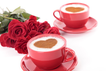 Cappuccino with heart shape dusting and bunch of red roses