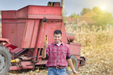 Farmer showing corn cob