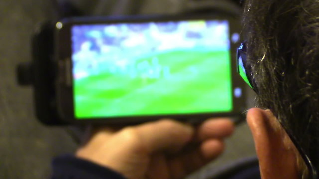 Man watching football match on tablet computer