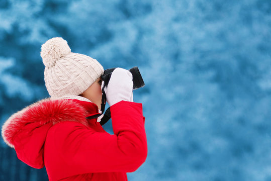 Woman photographer takes picture on the digital camera outdoors