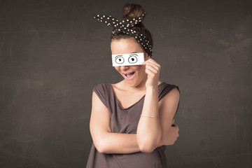 Funny woman looking with hand drawn paper eyes