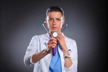 Female doctor with a stethoscope listening, isolated on grey