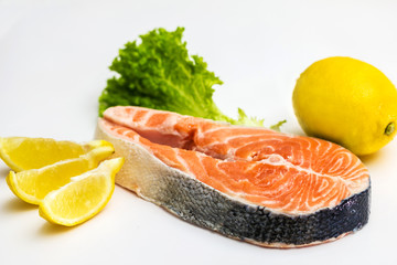 Raw Salmon Red Fish Steak with Herbs and Lemon isolated on White
