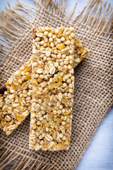 Muesli bars, cereal bars on the wooden background.