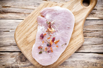 Pork chop, meat slices  on a wood background.