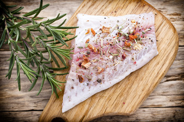 Fish fillet in spices and rosemary.