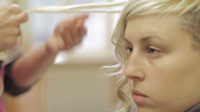 a focused woman at the hairdresser - hairdresser - hairstylist