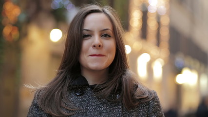 beautiful and smiling woman looking at the camera - light in background - Powered by Adobe