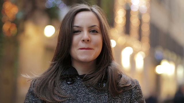 beautiful and smiling woman looking at the camera - light in background - Powered by Adobe