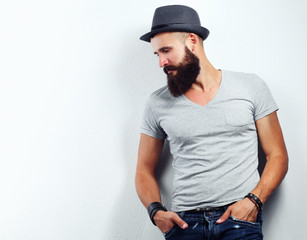 Portrait of handsome bearded man in hat standing , isolated on