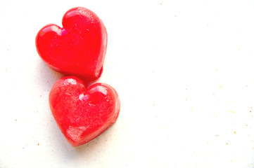 Two red ice cubes in shape of hearts