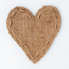  Symbolic heart of burlap lies on a white background