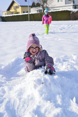 Fototapeta na wymiar Little girl with glasses playing in the snow
