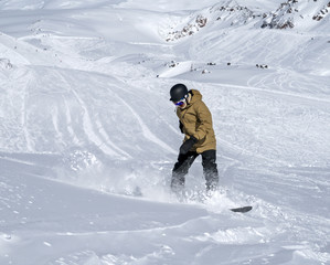 Fototapeta na wymiar Snowboarder moving down