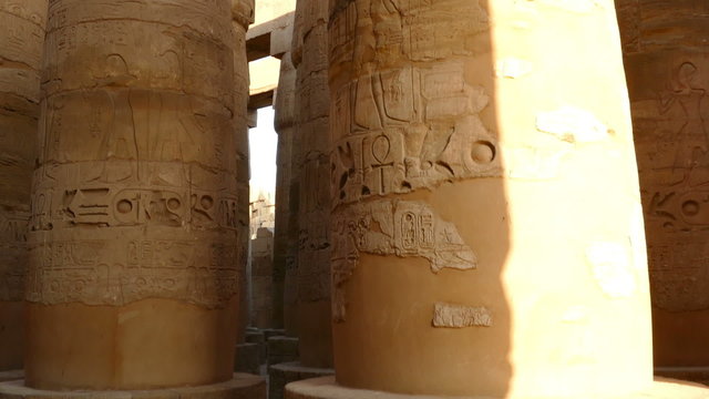 columns in karnak temple with ancient egypt hieroglyphics - tilt