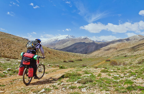 Cyclist racing on mountain trail