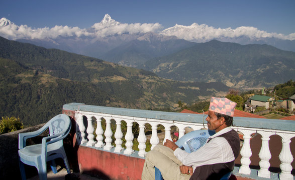 nepali men and the anapurna mountain range